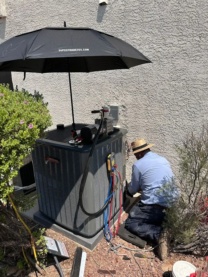 HVAC technician performing outdoor AC maintenance in Midlothian